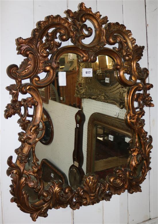 Ornate gilt framed wall mirror(-)